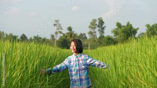 Young Girl in Rice Field: A young girl, lost in a vibrant rice field, explores the endless green landscape, representing the freedom of youth and the beauty of nature.