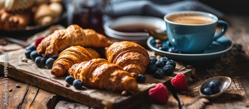 Focused breakfast with coffee and croissants. photo