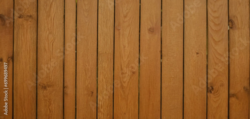 This image shows a close-up view of a wooden surface  characterized by horizontal planks with visible grains and textures. The wood has a dark brown color  and the lines between the planks are clearly