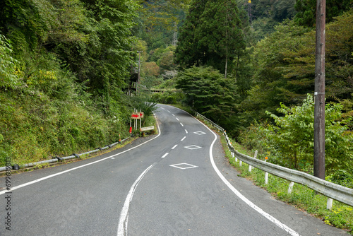 Walking the hiking road following the Nakasendo trail between Tsumago and Magome in Kiso Valley, Japan.