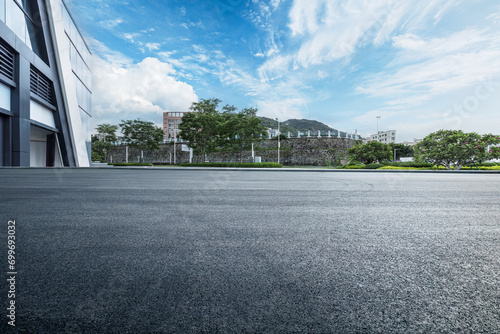 Empty asphalt and city buildings landscape in summer photo