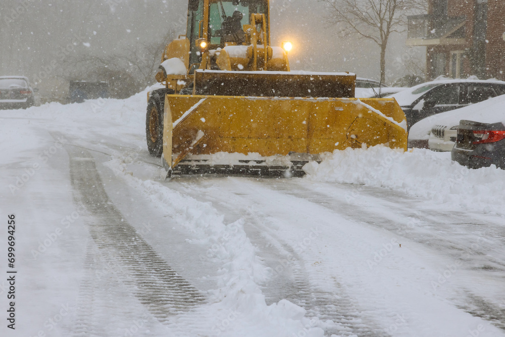 Snowplow trucks remove snow from parking lots following heavy snowfalls Snowplow trucks remove snow from parking lots following heavy snowfalls