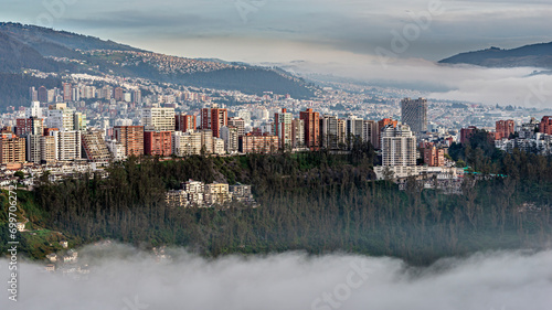 Gonzalez Suarez district skyscrapers above the Guapulo valley with mist photo