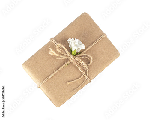 Gift box. Craft paper wrapped gift bandaged with jute rope, decorated with fresh flower, top view. Eco friendly and zero waste packaging.
