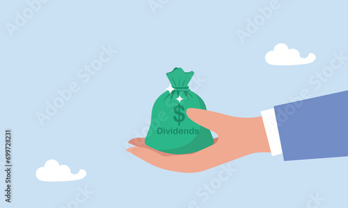 Dividend stocks, public company payback profit in stock market, return or profit from investment concept, Businessman investor hand holding big money bag with label Dividends and dollar money sign. photo