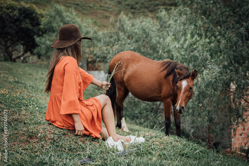 woman feeding a horse