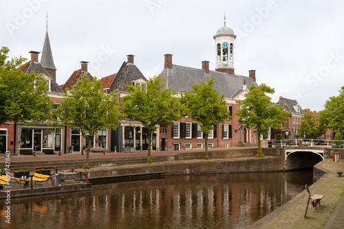 Historic canal houses and the town hall in the center of the picturesque town of Dokkum in Friesland. photo