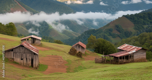 Rustic wooden building with metal roofs on a grassy hill, picturesque landscape of a rural area, dirt path, misty mountains photo