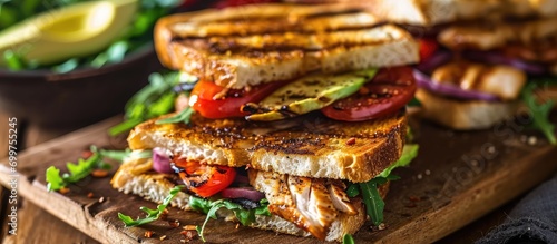 Chicken and avocado added to grilled BLT sandwiches.