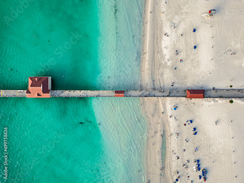 Coastal city with a view of the ocean, taken from above with a drone. Clearwater Beach. Pier at clearwater beach jutting into the ocean at sunset
