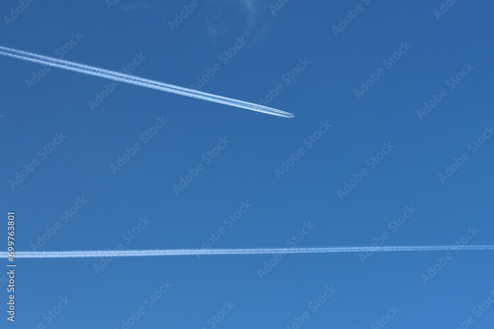 Airplane with contrails in the deep blue sky Airplane with contrails in the deep blue sky
