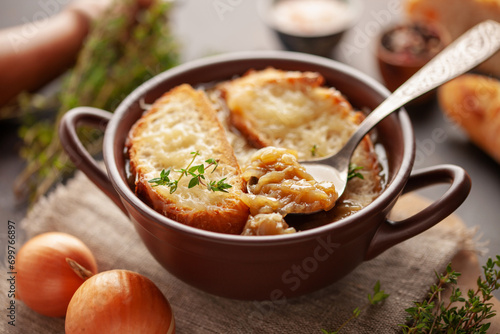 Classic French onion soup baked with cheese croutons sprinkled with fresh thyme