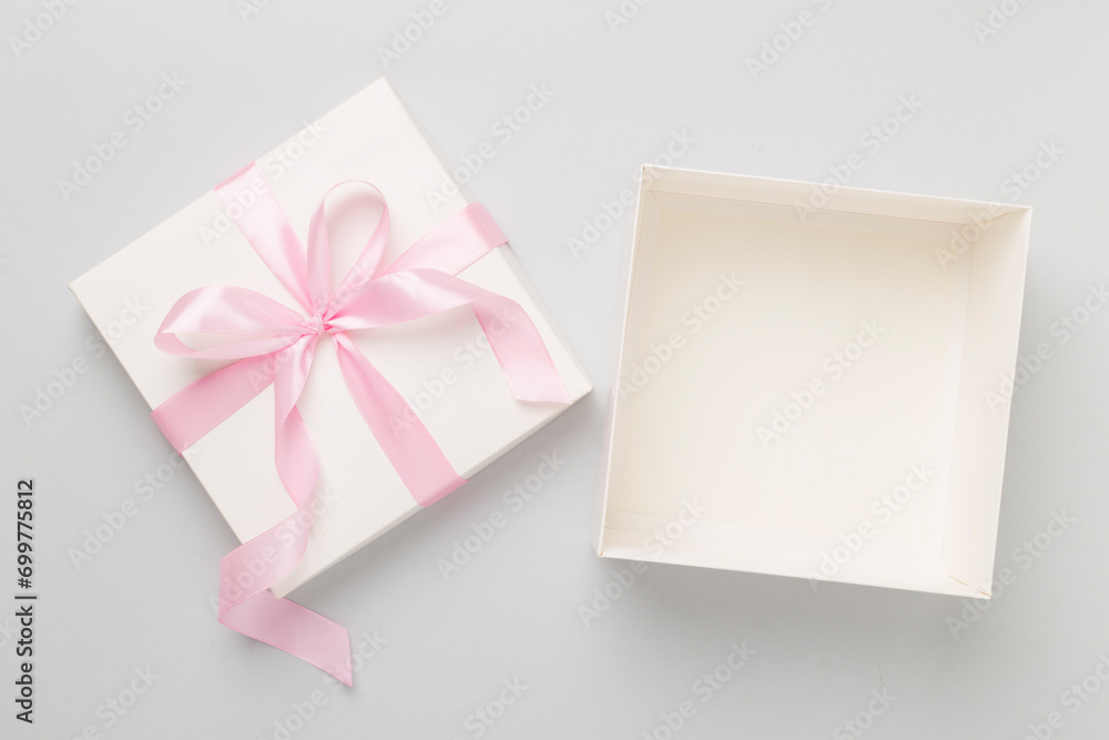 White open gift box on color background, top view. Mock up for design White open gift box on color background, top view. Mock up for design
