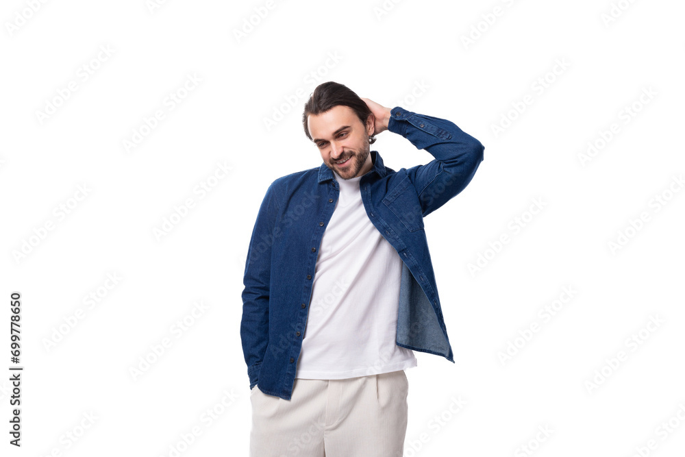 handsome young brunette man in a denim shirt on a white background handsome young brunette man in a denim shirt on a white background