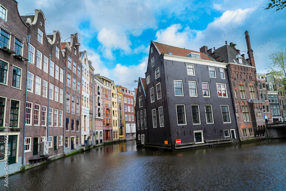 Facades of old histoic Houses over canal water, dutch scenery of Amsterdam, Netherlands