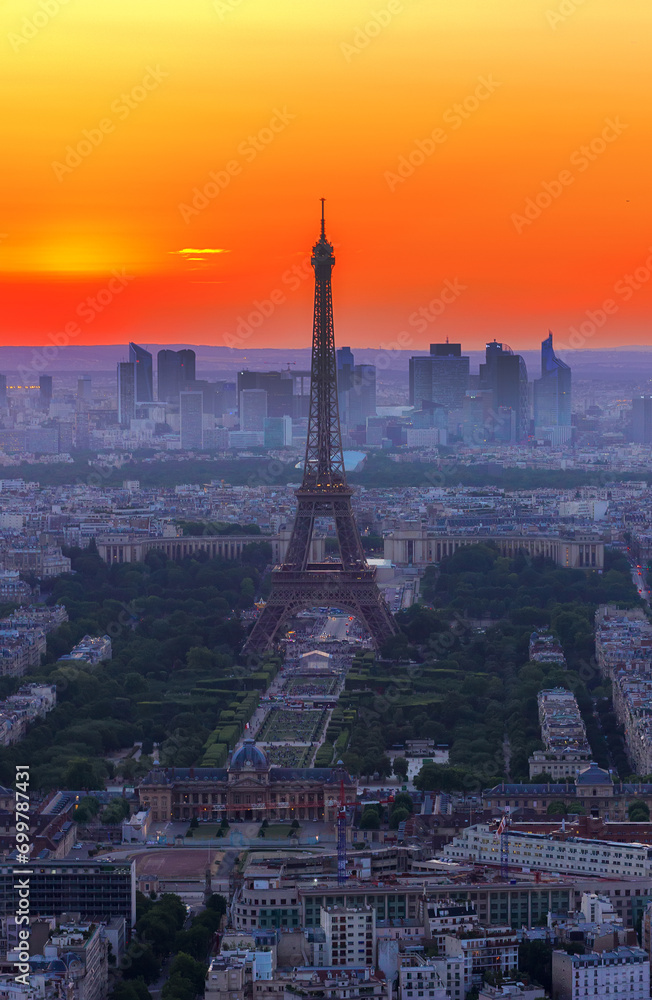 cityscape of Paris with Eiffel Tower from above in orange sunset sunlight, France