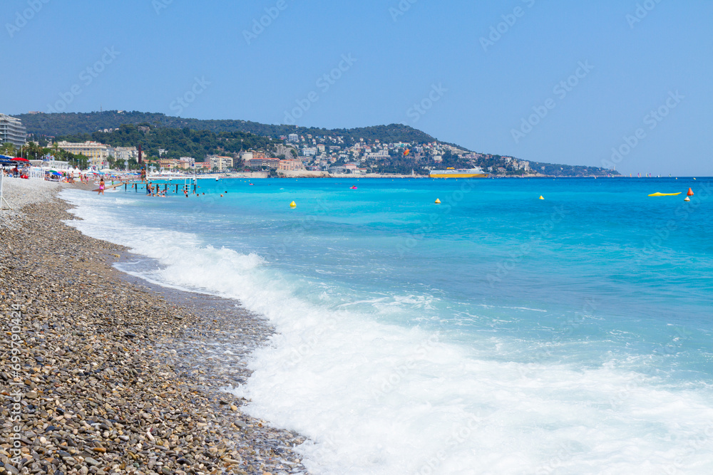 stone pebble beach and turquiose water of cote dAzur at Nice, Riviera, France