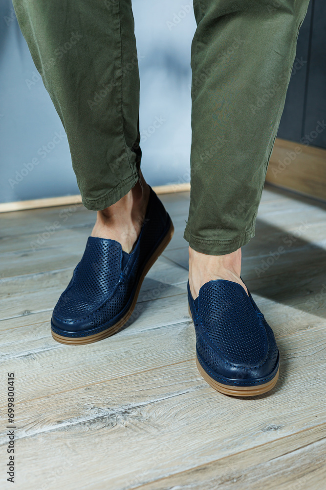 Male legs in blue leather shoes. Men's classic shoes.