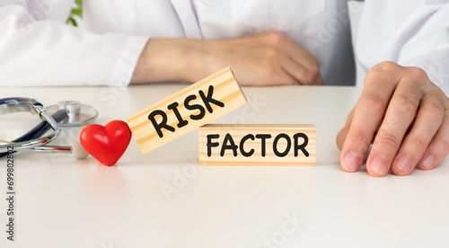 Text risk factors from wooden blocks with stethoscope photo
