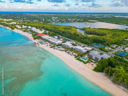 7 Seven Mile Beach Grand Cayman Cayman Islands pristine turquoise blue water white sand Caribbean sea Atlantic ocean hotels beachfront villas condos sunrise sunny day sky and clouds lush greenery