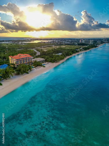 7 Seven Mile Beach Grand Cayman Cayman Islands pristine turquoise blue water white sand Caribbean sea Atlantic ocean hotels beachfront villas condos sunrise sunny day sky and clouds lush greenery © DELVIT