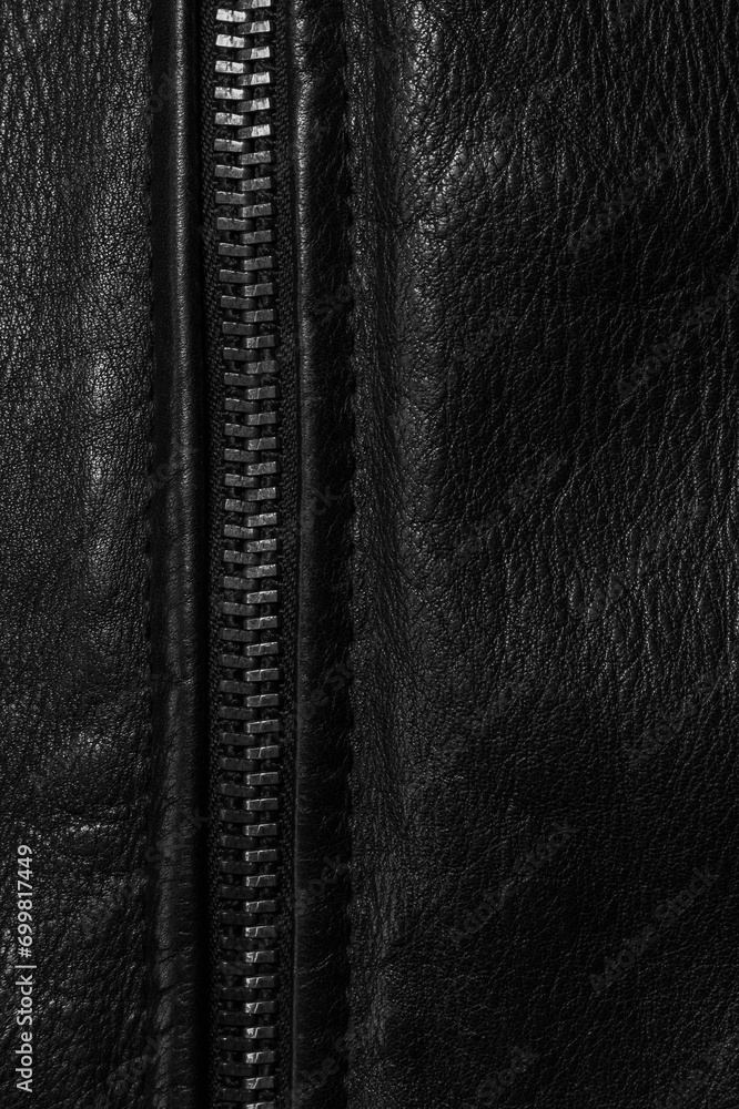 Black leather background with metal zipper close-up. Abstract dark leather texture Black leather background with metal zipper close-up. Abstract dark leather texture