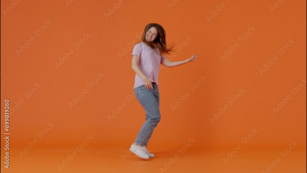 Female imitating playing guitar while jumping in studio Female imitating playing guitar while jumping in studio