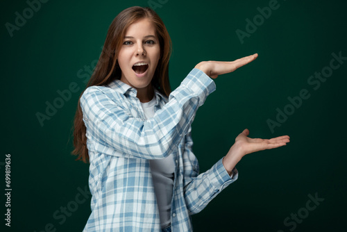 30 year old cheerful young lady with gorgeous long brown hair on a green background