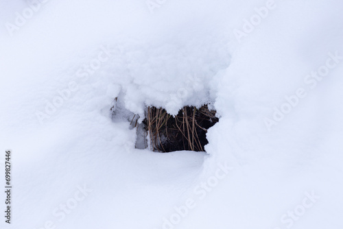 a small hole or cave in the snow