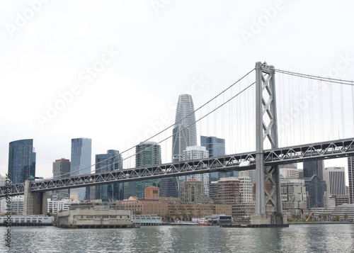 San Francisco city financial district with Bay Bridge in foreground. The Bay Bridge is part of Interstate 80 and a direct road between San Francisco and Oakland.