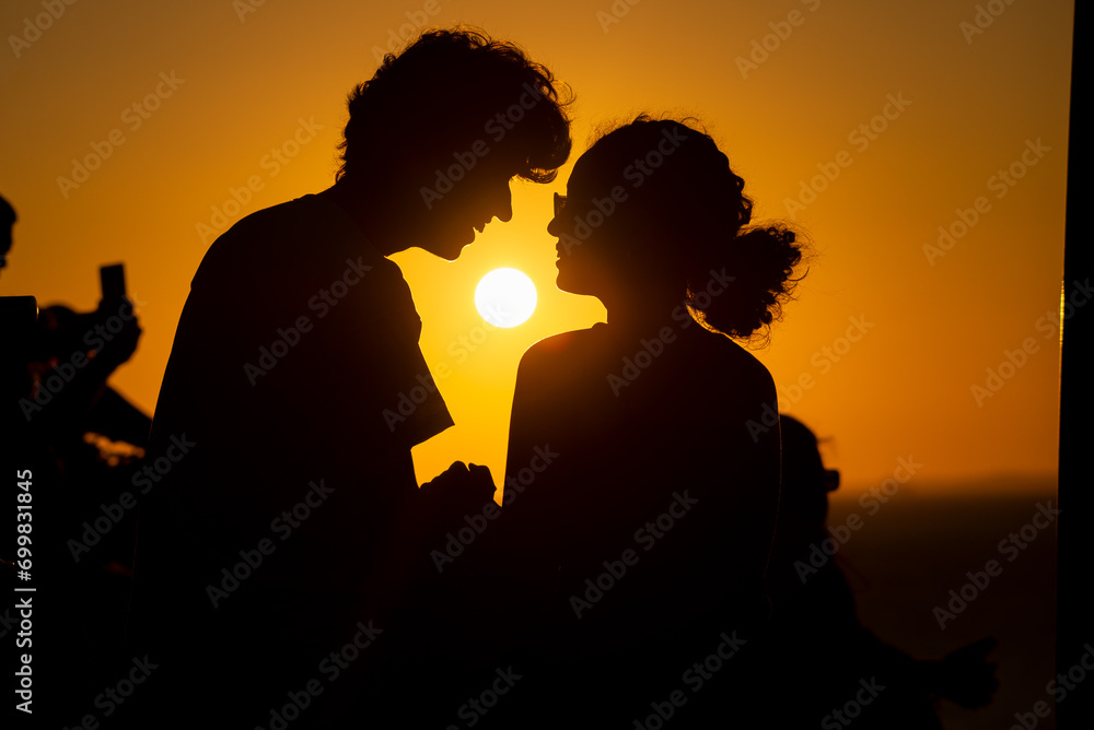 Young couple in silhouette, in late afternoon.
