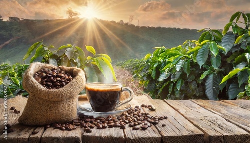 A steaming cup of coffee with a burlap sack of beans on a wooden table, against the backdrop of a scenic coffee plantation at sunrise photo