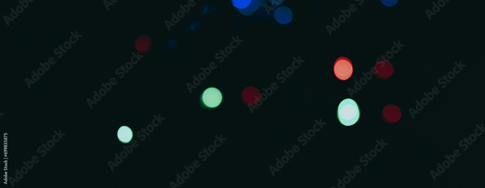 dark backdrop with a multicolored bokeh effect from scattered, out-of-focus light spots. dark backdrop with a multicolored bokeh effect from scattered, out-of-focus light spots.