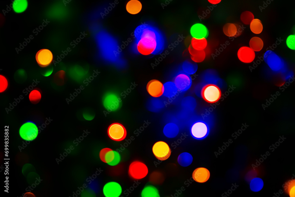 festive and magical atmosphere with multicolored bokeh lights scattered against a dark background. festive and magical atmosphere with multicolored bokeh lights scattered against a dark background.