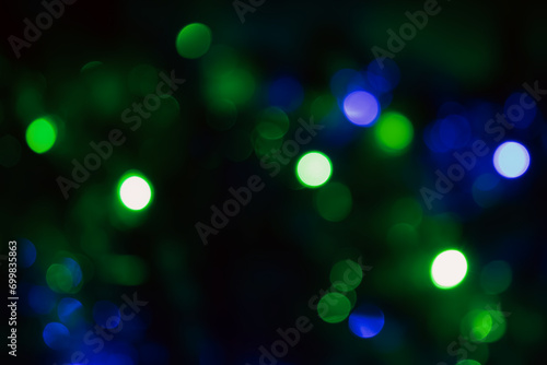 close-up of green and blue bokeh lights against a dark backdrop, conjuring a dreamy and magical ambiance.