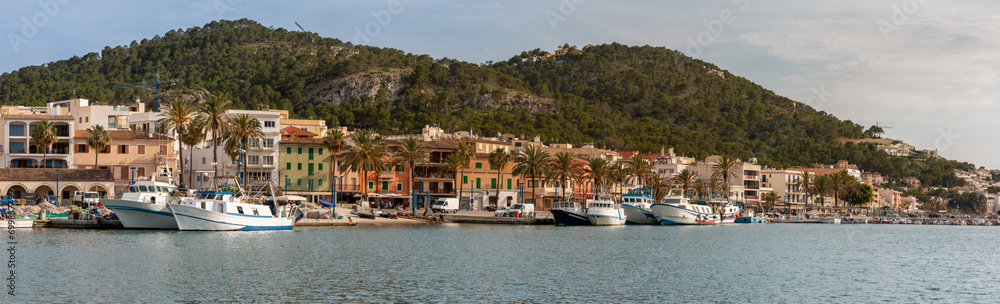 Panoramic view of the dock with fishery ships in Andratx in the island of Majorca, Spain with mountains in background