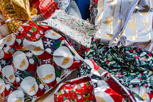 Discarded Christmas wrapping paper left in a pile on the floor having been ripped off Christmas presents