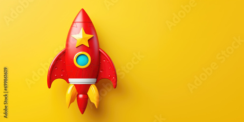 Red Rocket Toy on Yellow Background with Copy Space photo