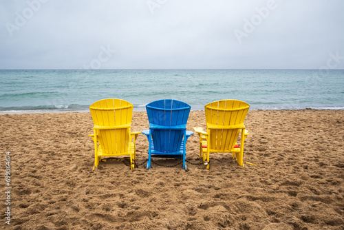 Photography beach chairs in the sand looking out to the horizon of lake ontario from kew bea