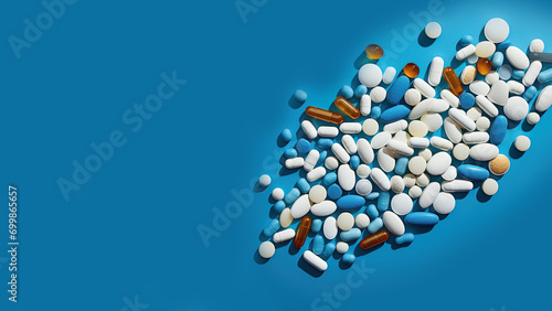 Pills and capsules on a blue background. Medicament. Medication. Composition with a bunch of colorful pills, capsules and antiviral drugs. D3. Background of the pharmaceutical industry. TOP View 