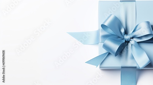 Large blue ribbon bow on left of long ribbon for banner, isolated on white with copy space
