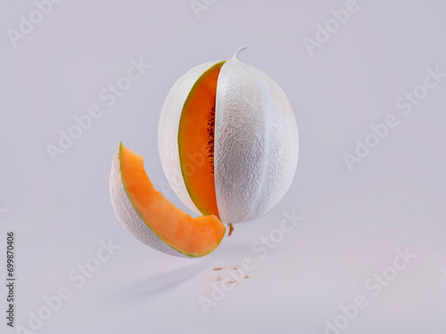 Yellow melon painted white hovering mid air against a white background photo