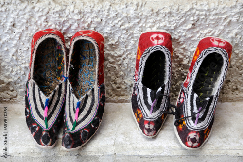 Close-up of two pairs of Traditional Ladakhi shoes for sale in a bazaar, Leh, Ladak, Jammu and Kashmir, India photo