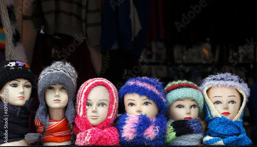 Row of mannequins with woolly scarves and hats for sale in a market, Manali, Himachal Pradesh, India photo