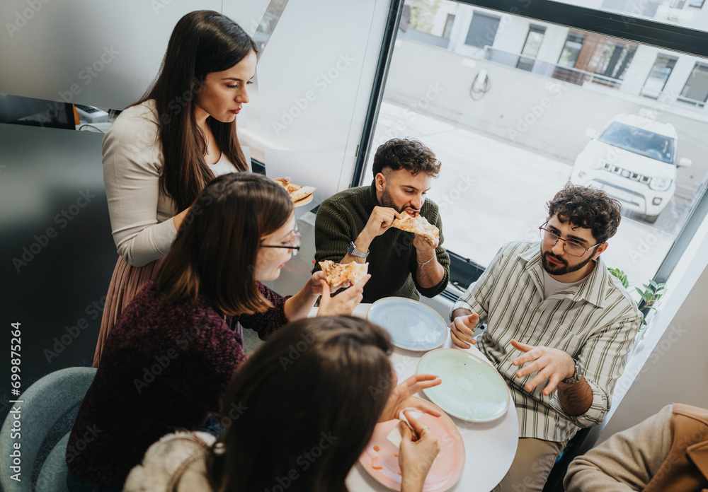 Fototapeta premium Diverse business team enjoying pizza break, fostering successful teamwork.