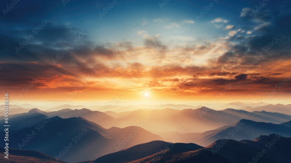 Sunrise casting light over layered mountain ranges