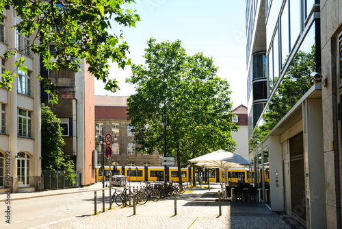 Canvas Print View of city street with buildings and cafe