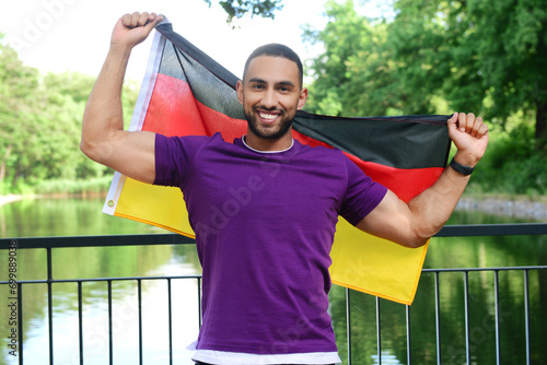 Young man with flag of Germ...
