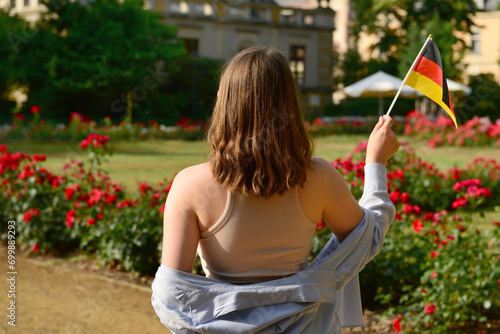 Young woman with flag of Ge...