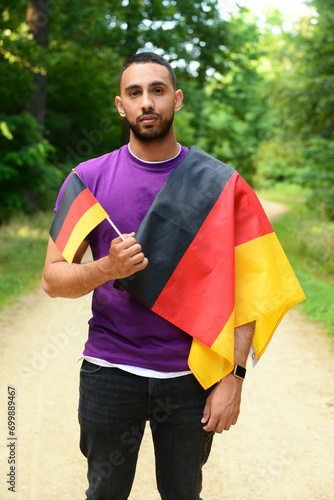 Young man with flags of Ger...